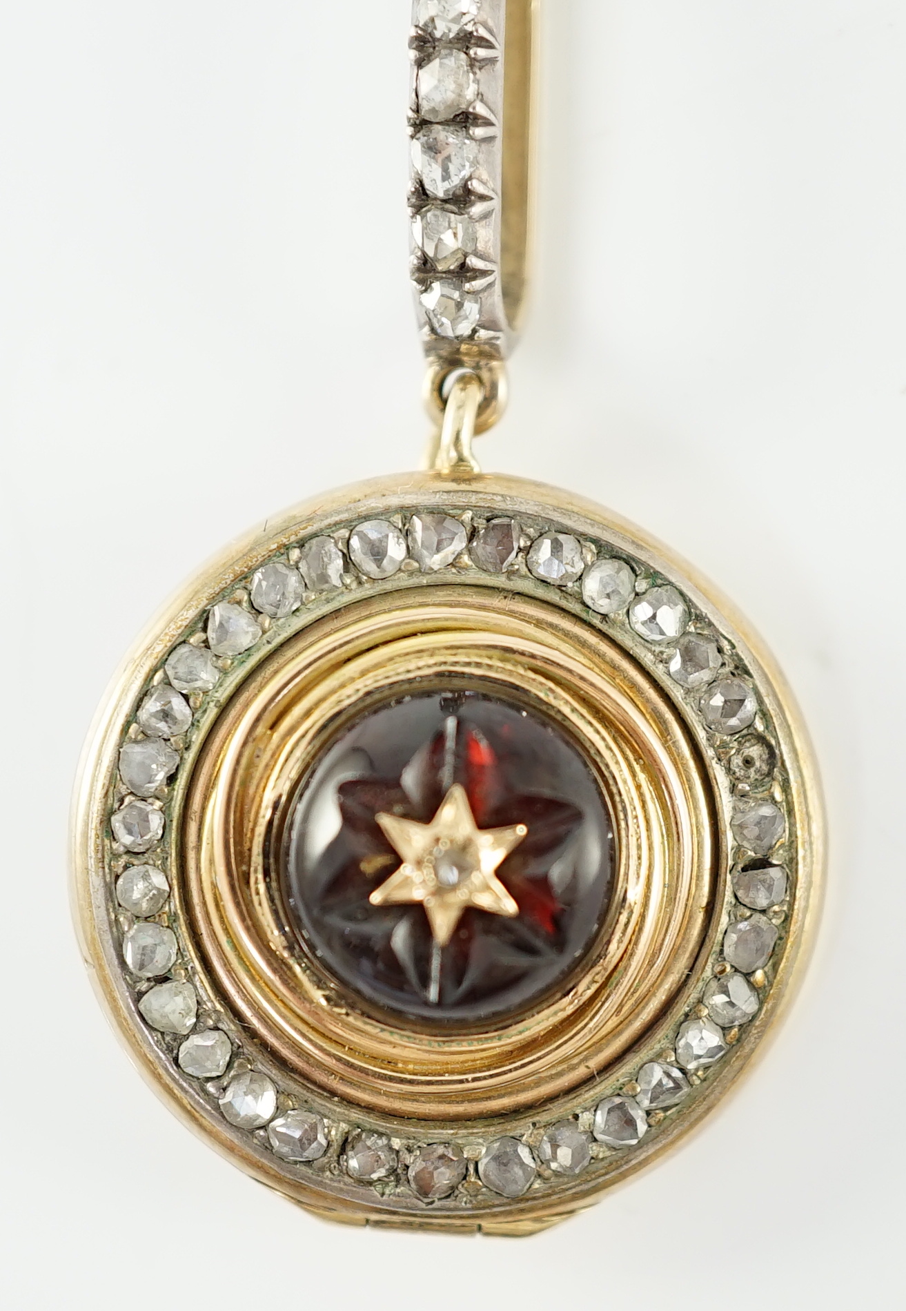 A 19th century gold, cabochon garnet and rose cut diamond set cluster target pendant